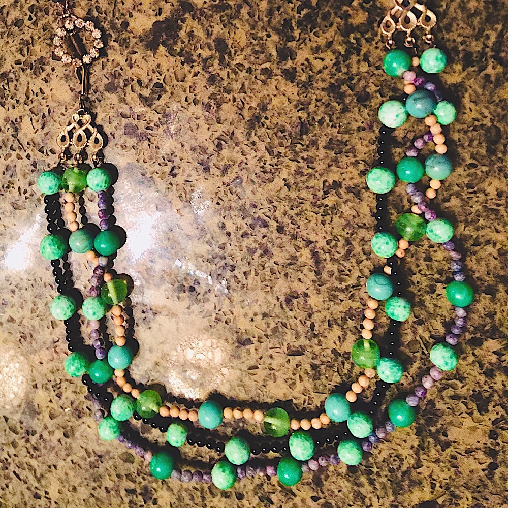 Teal Beads Amongst A Circle of Diamonds and Leaves